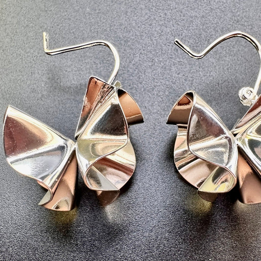 Close-up of petal-like curves and polished metal surface