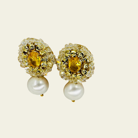 Close-up of 9.5mm cultured pearl suspended below floral zirconia cluster