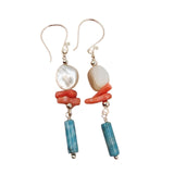 Close-up of white shell, red coral, and blue agate on silver chain