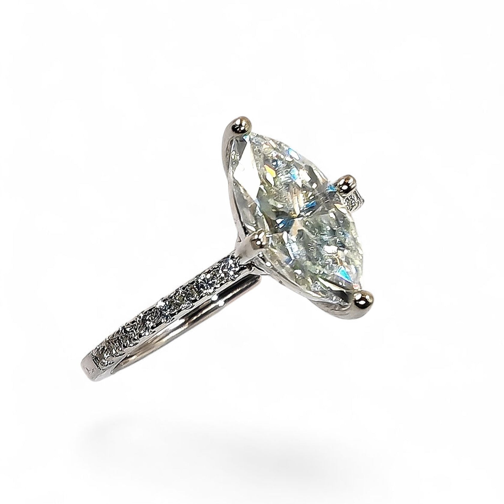 Close-up of marquise-cut moissanite and pavé halo
