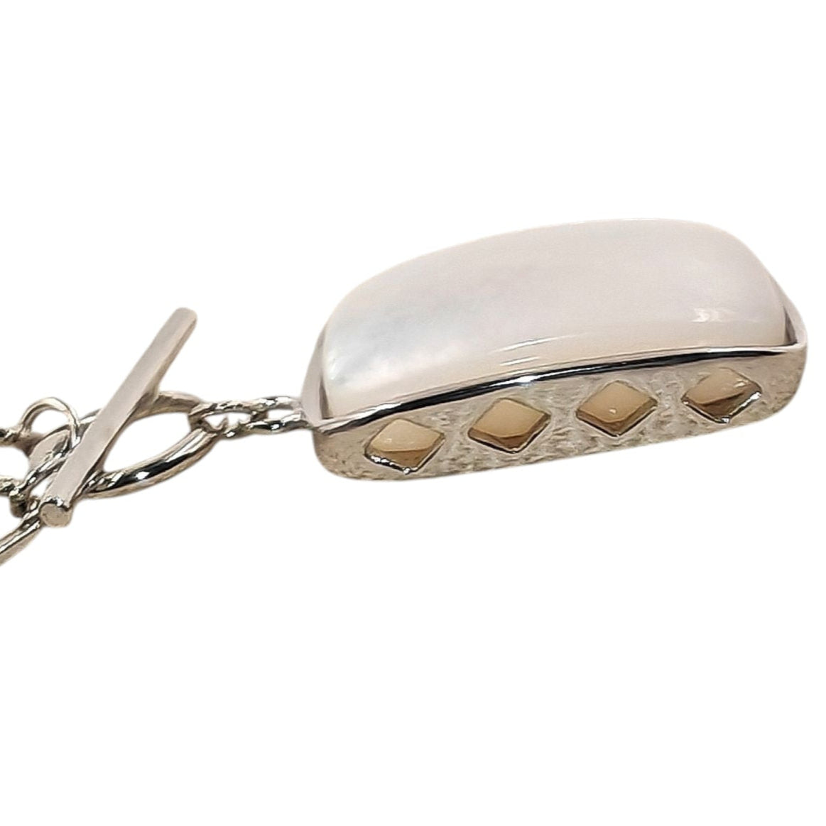 Close-up of rectangular pendant and silver casement
