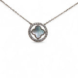 Close-up of cross pendant and zirconia halo