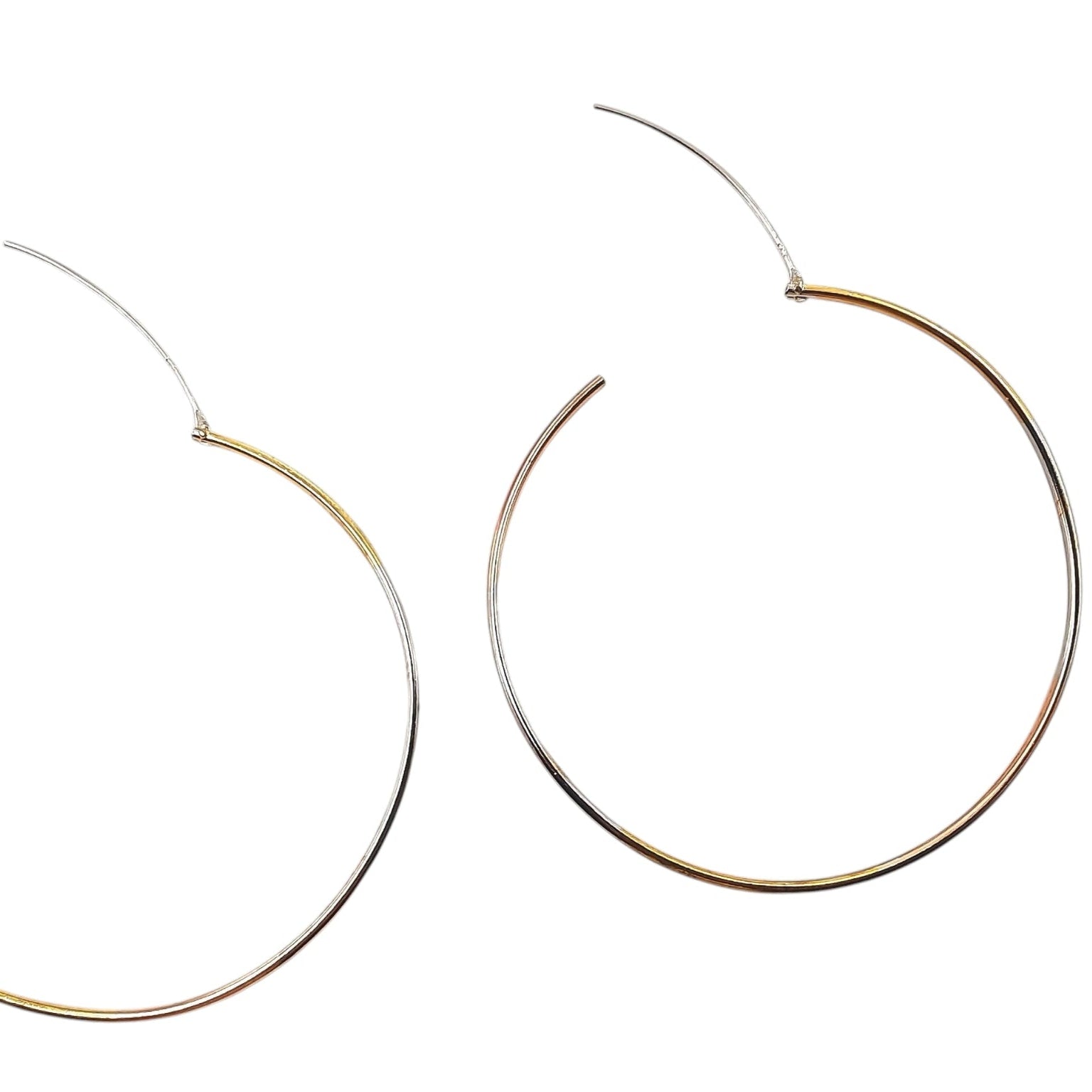 Close-up of two-tone hoop earrings showing hinge and clasp