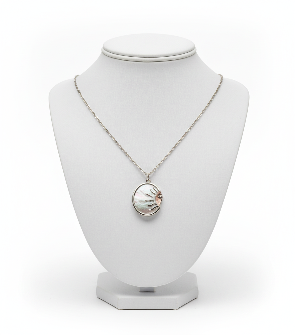 Necklace with a circular pendant on a white mannequin bust against a white background
