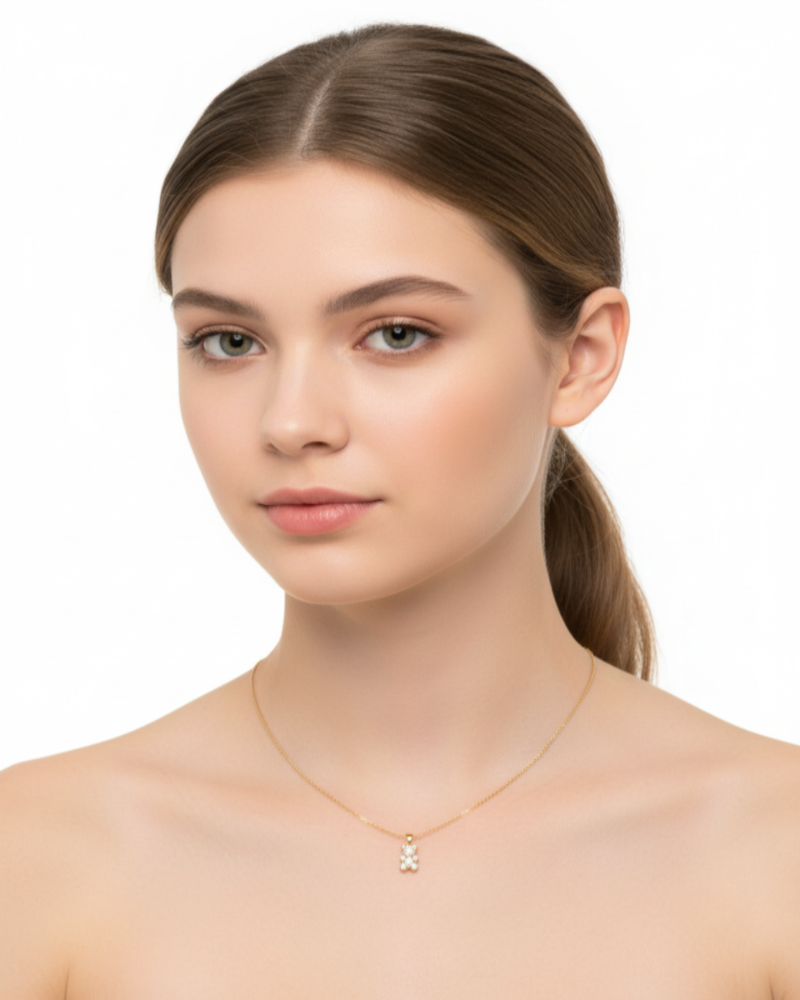 Woman wearing a gold necklace with a small pendant on a white background fugugemz