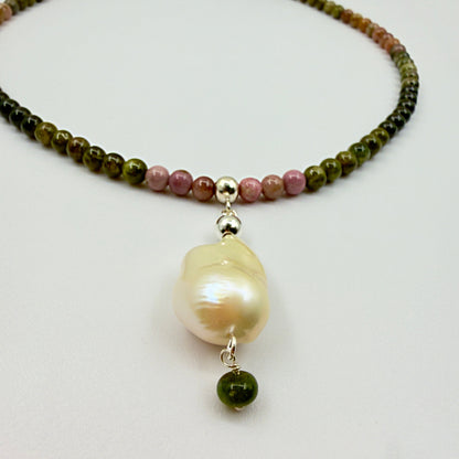 Close-up of baroque pearl pendant and multi-color tourmaline beads