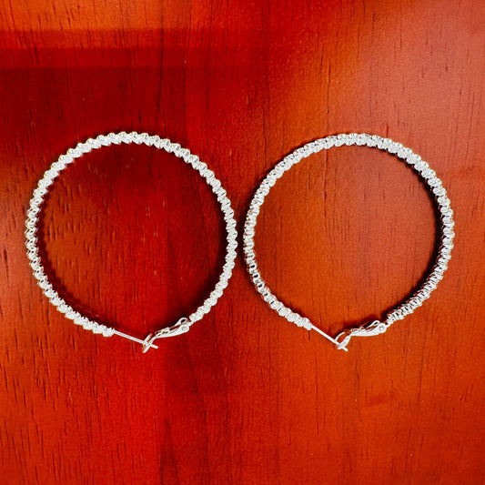 Side view showing depth and curvature of woven hoop earrings