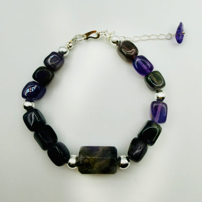 Bracelet with black and purple beads on a white background