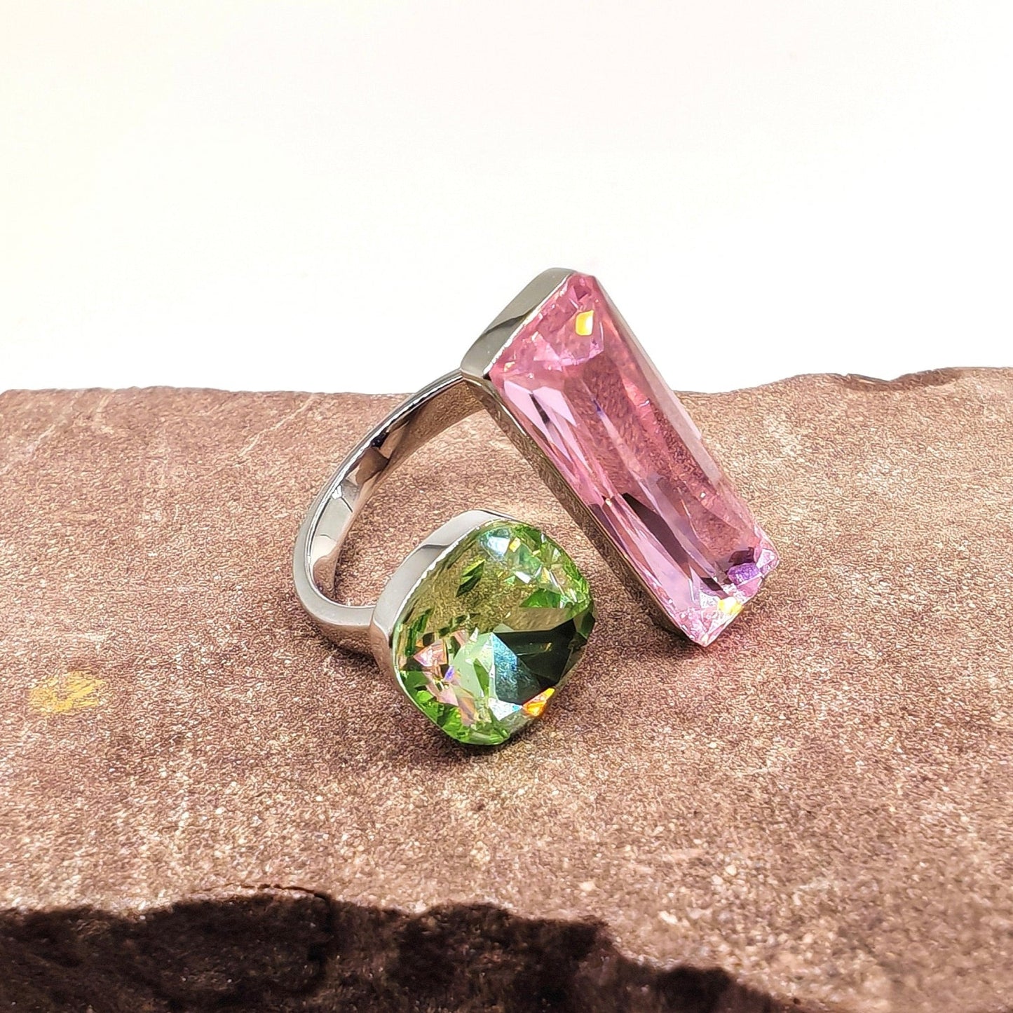 Close-up of pink and green crystals in brass setting
