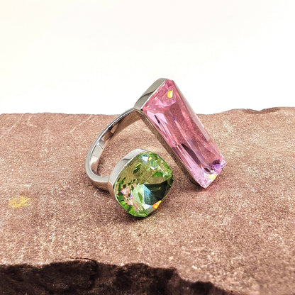 Close-up of pink and green crystals in brass setting