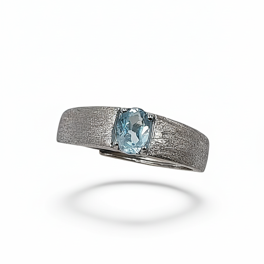 Silver ring with a blue gemstone on a white background