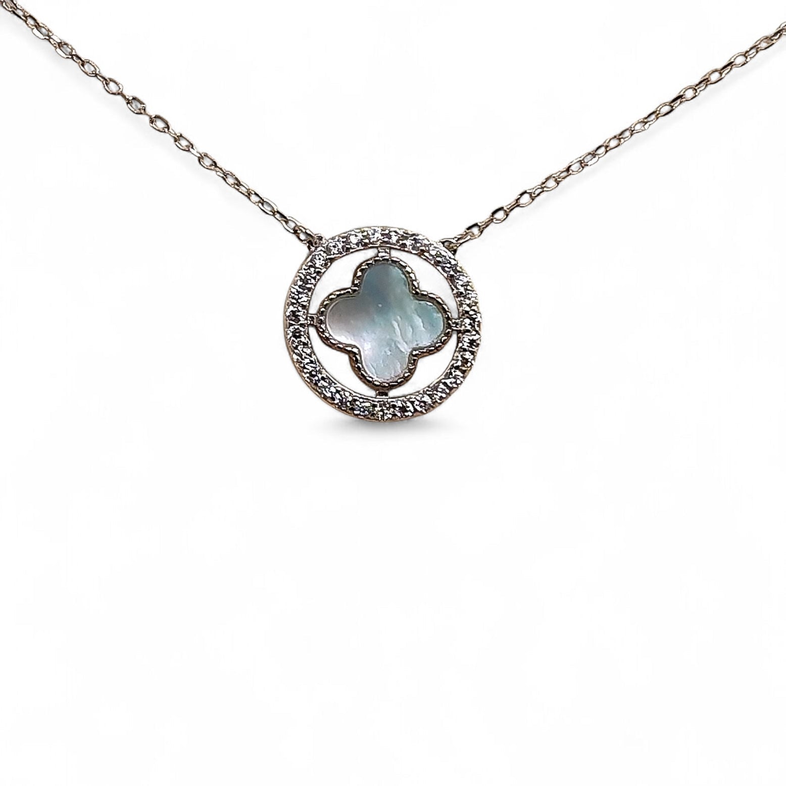 Close-up of cross pendant and zirconia halo