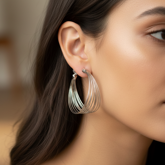 Woman wearing twisted rope hoop earrings 