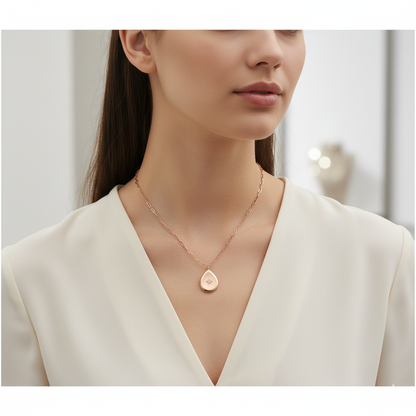 Woman wearing a delicate necklace with a heart pendant against a neutral background