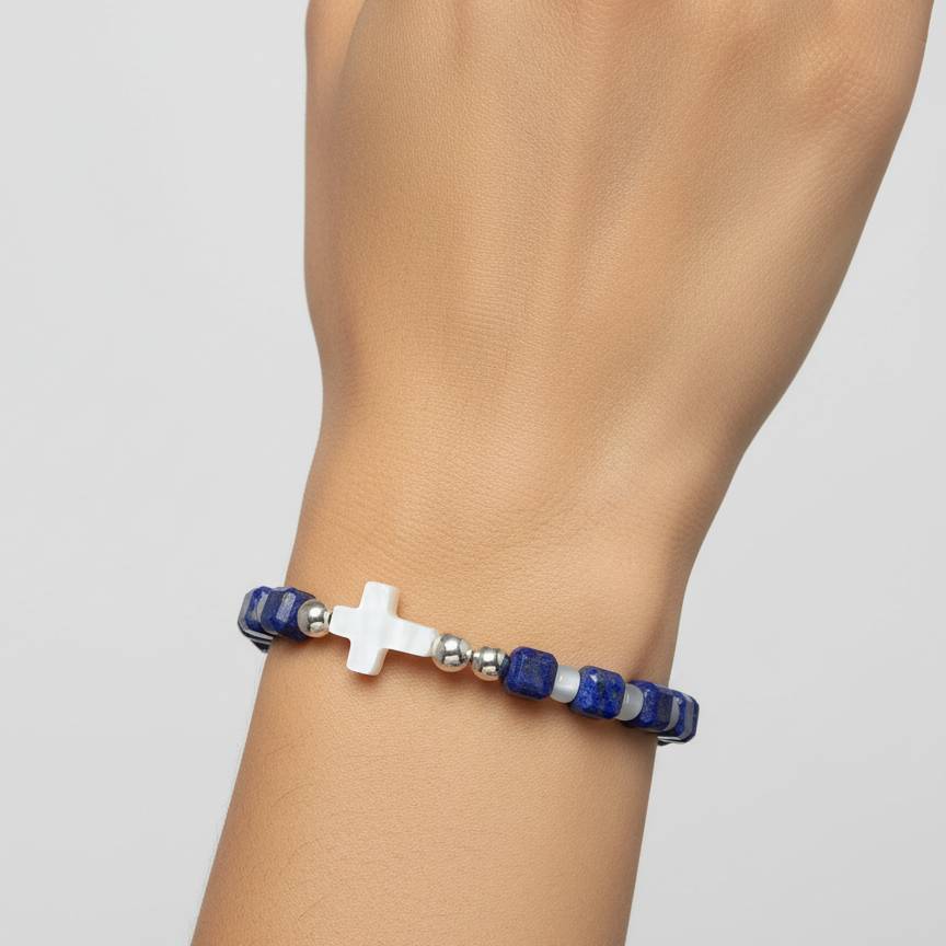 Close-up of the bracelet, highlighting the mother of pearl cross and the lapis beads. fugugemz