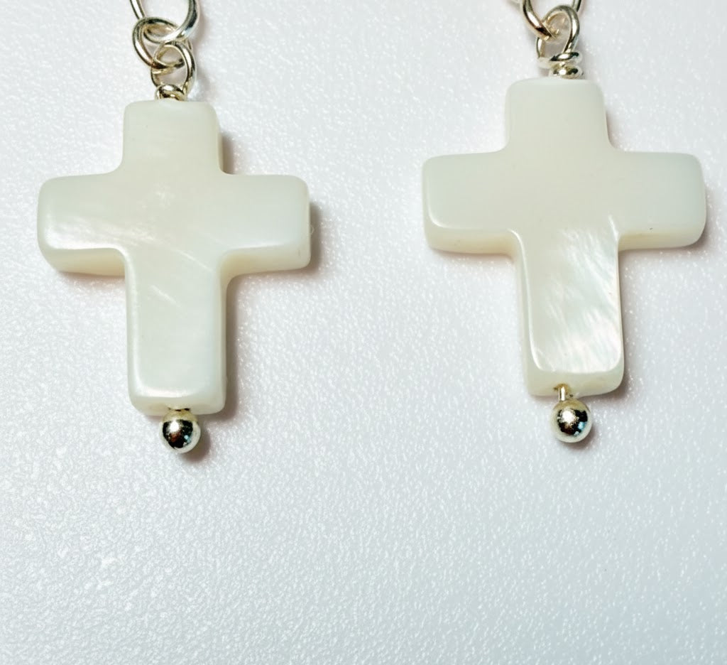 Image showing the full drop and the polished finish of the pearl cross earring.