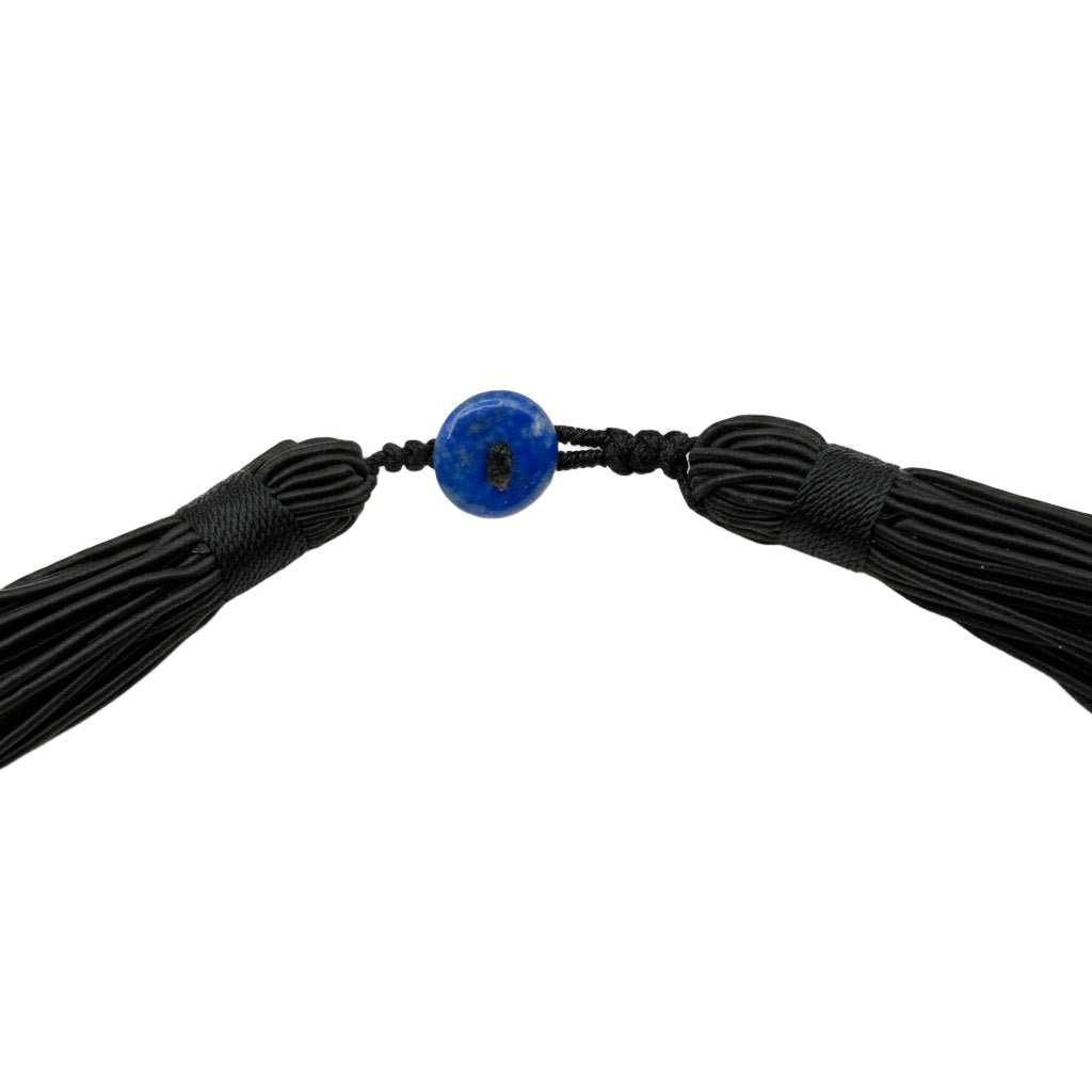 Black tassel necklace with a blue bead on a white background