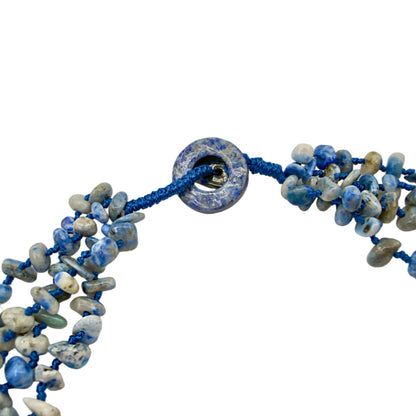 Close-up of blue/white shell bead details
