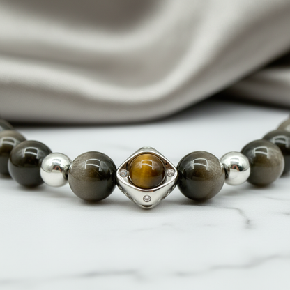 Necklace with brown and silver beads on a marble surface
